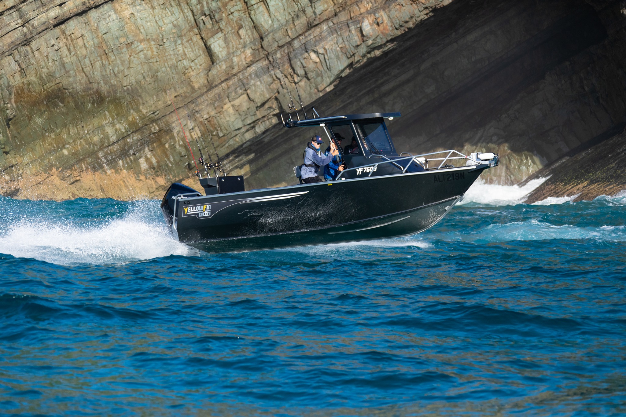 A Yellowfin hard top boat cruising on the ocean.
