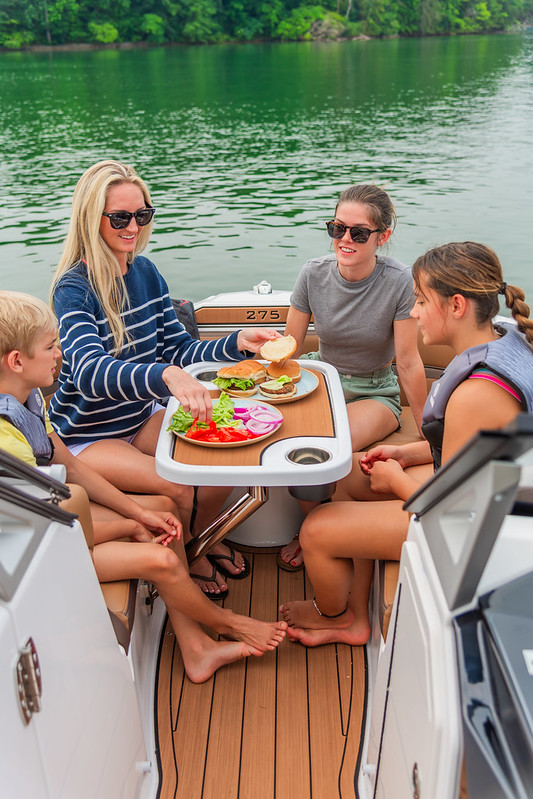 A family of four eating onboard a boat.