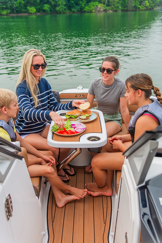 A family of four eating onboard a boat.