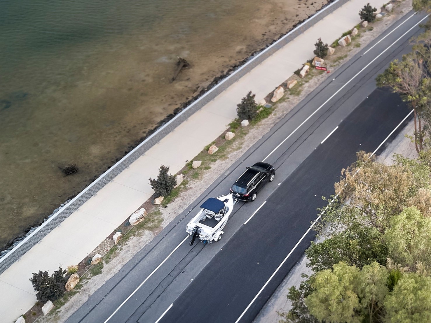 vehicle hauling a boat on a trailer on the road