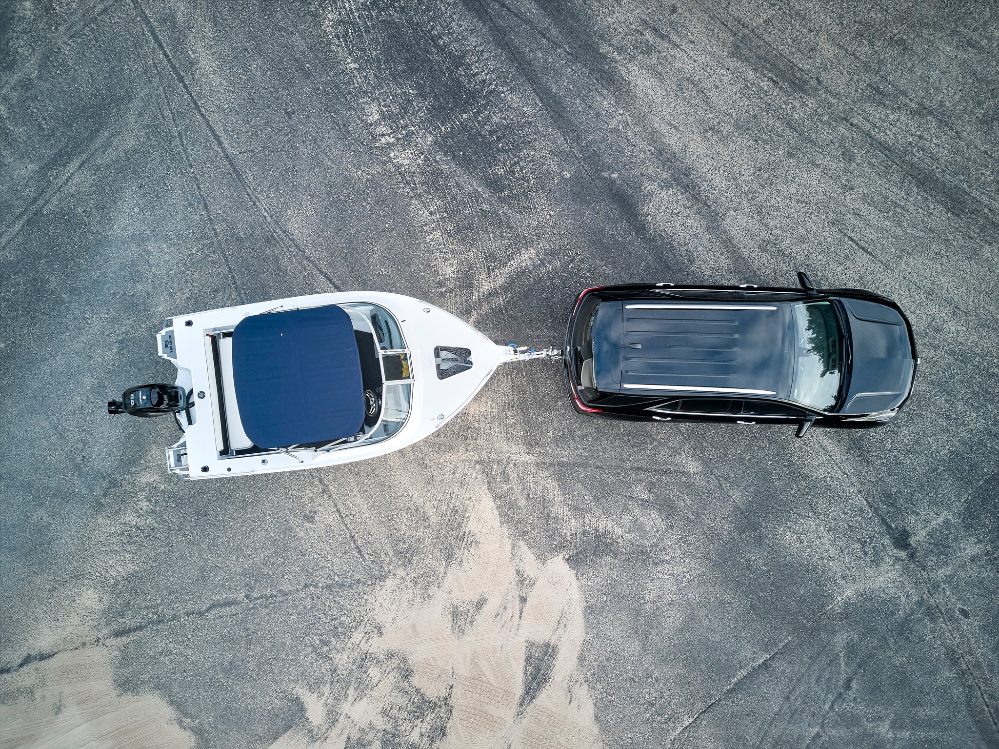 aluminium boat being towed by a car
