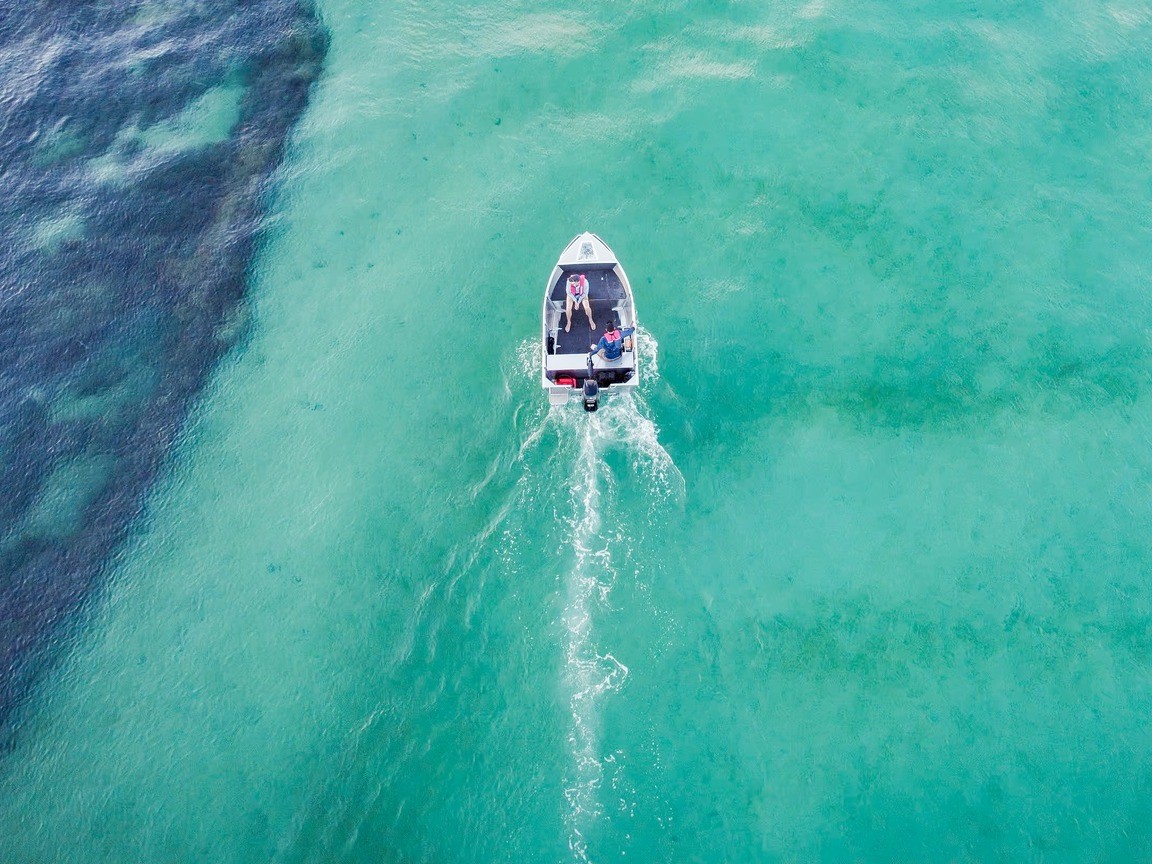 quintrex boats on  sandy shore of the blue sea