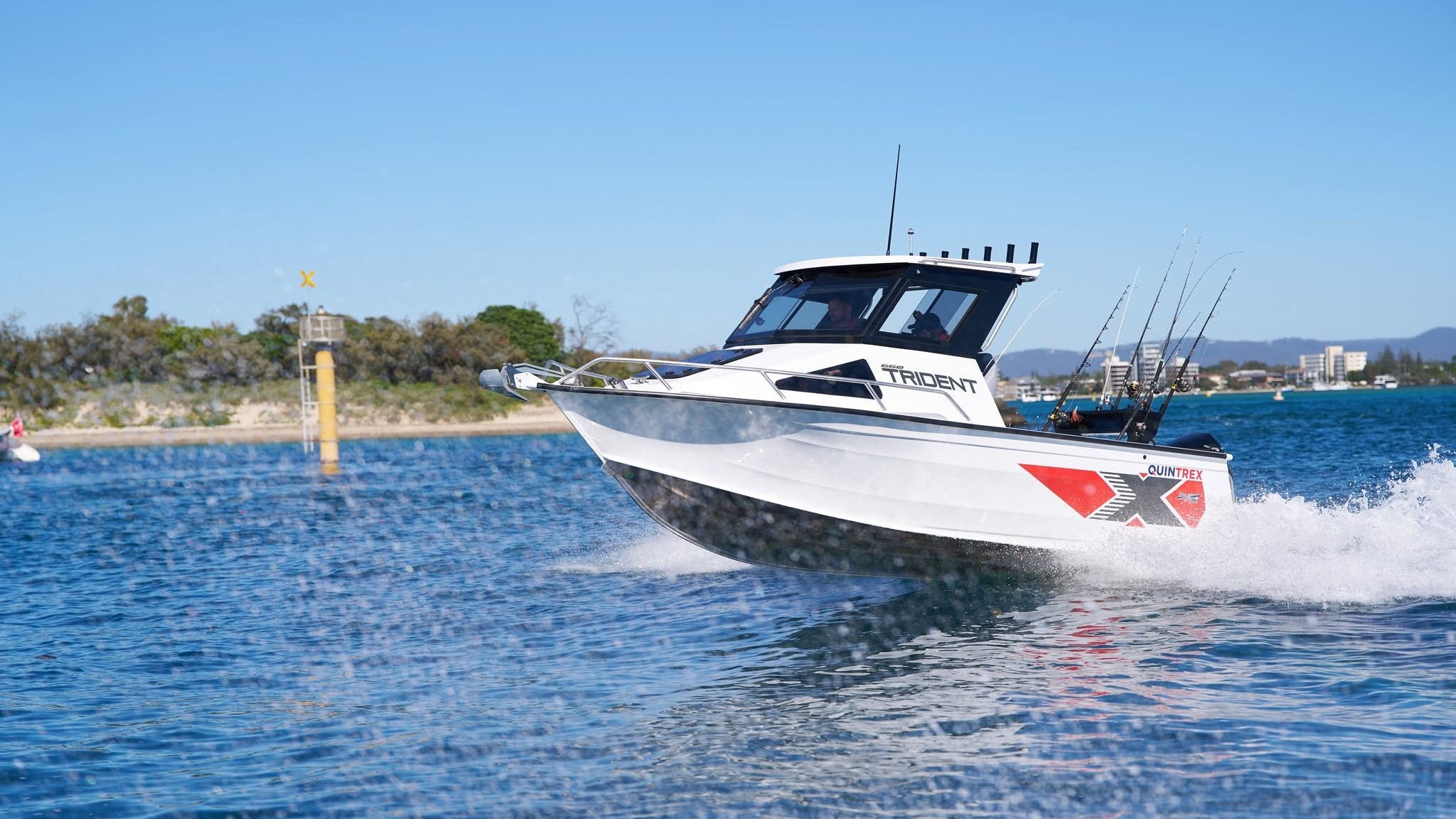 Quintrex Trident planing on water