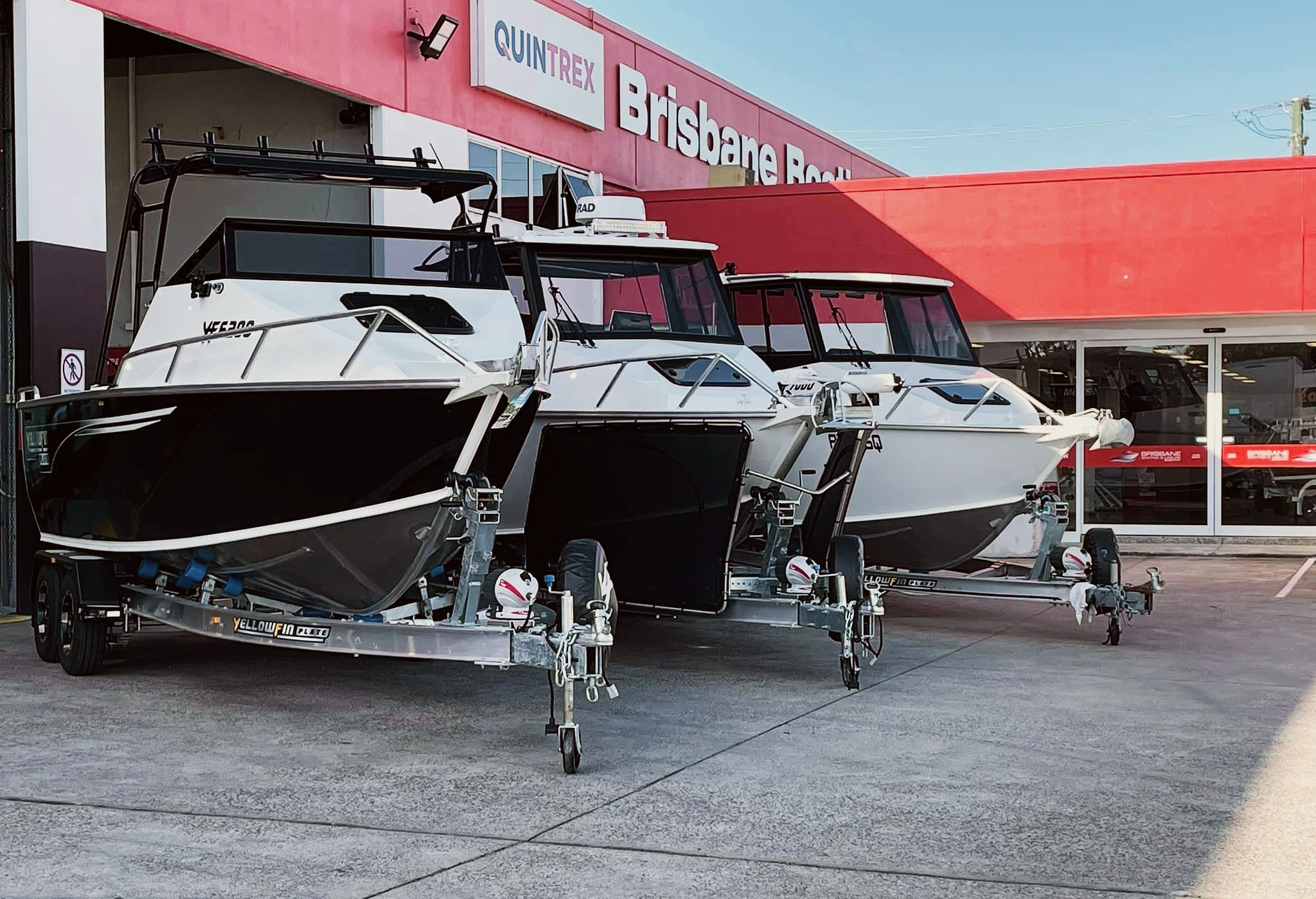 A row of Yellowfin boats lined up outside Brisbane Boating dealership.
