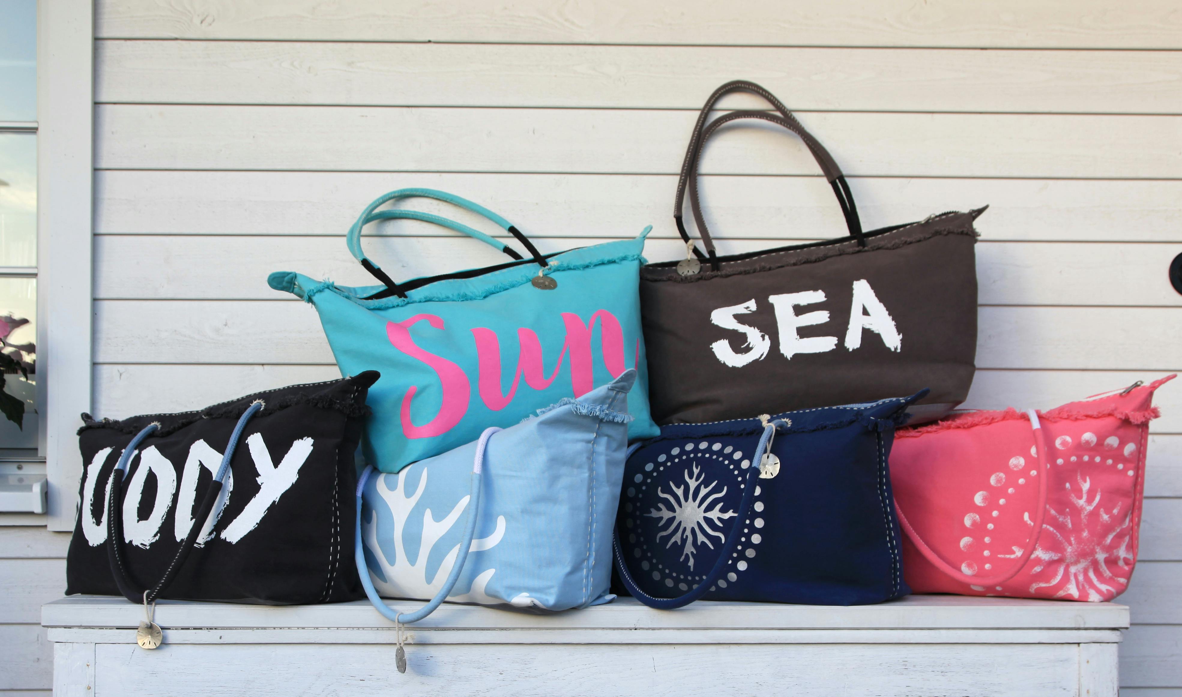 A group of tote bags stacked together.