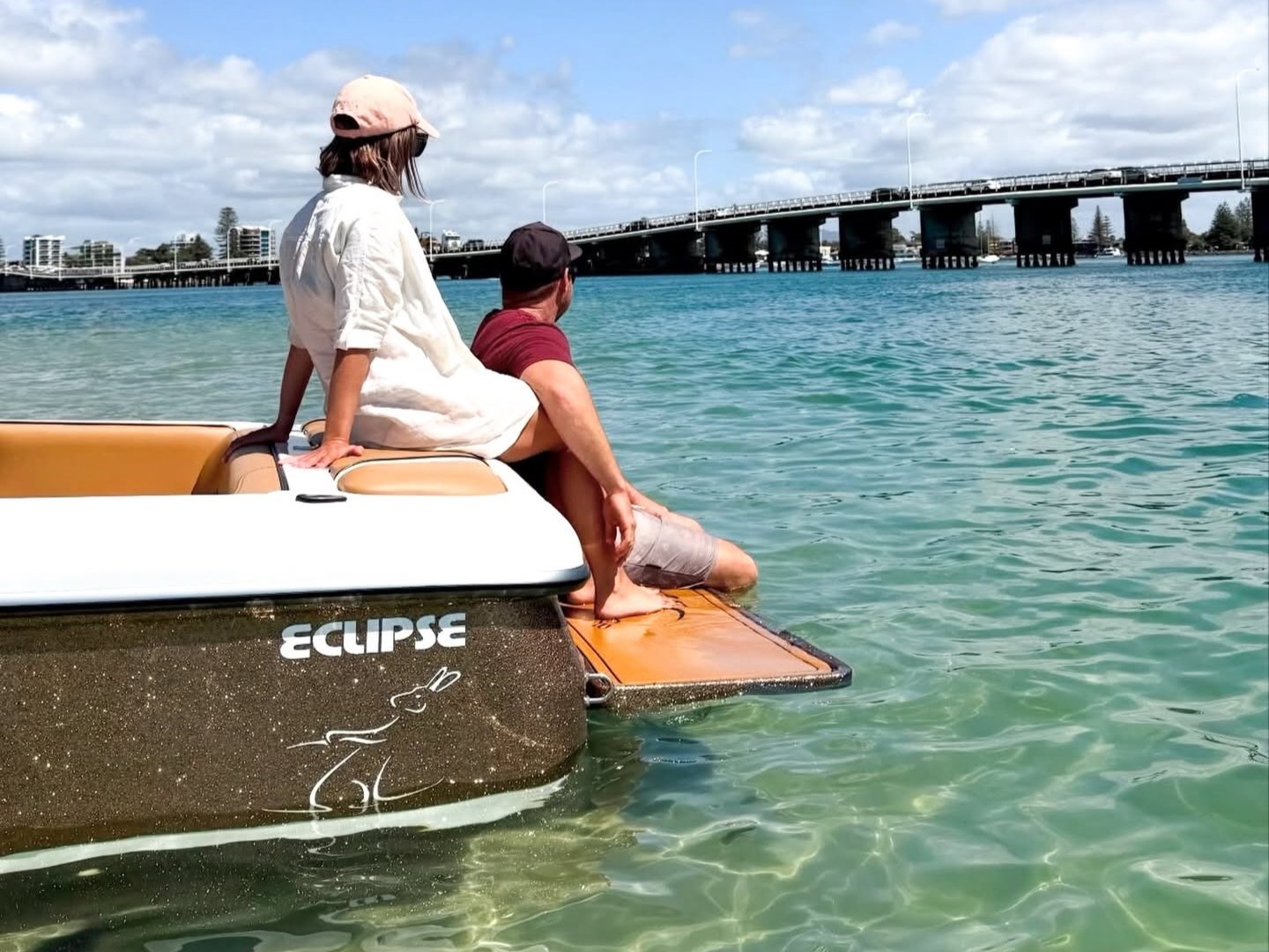 A man and woman on board at the back of a Lewis Eclipse boat