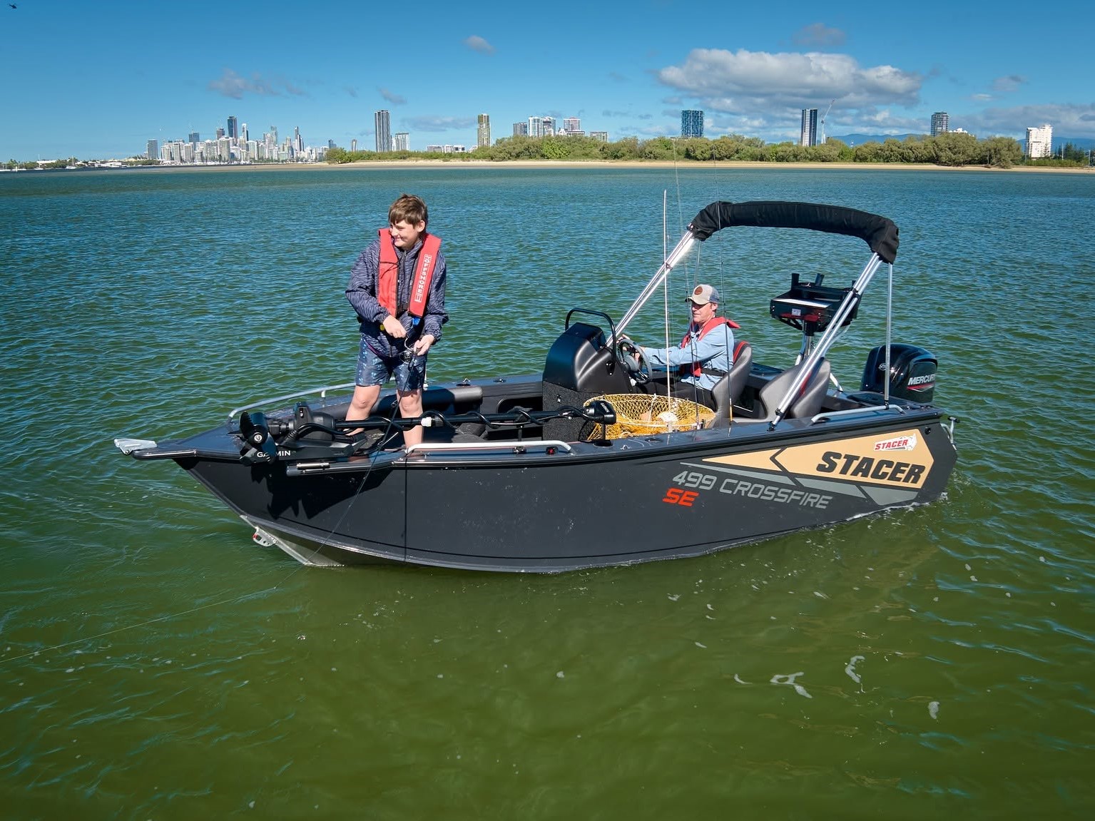 two men fishing on a 499 crossfire boat out on a calm lake on a sunny day